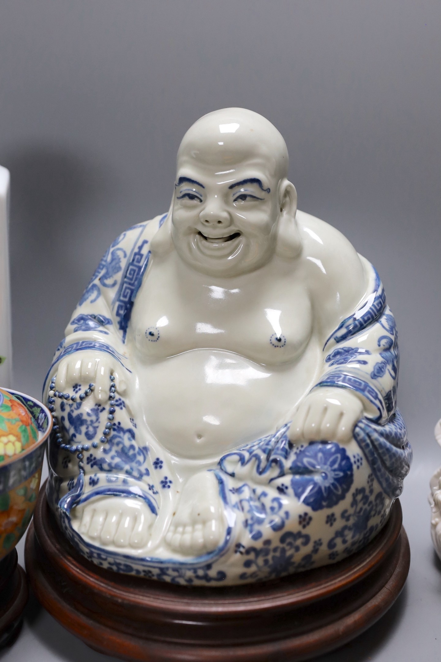 A Chinese peach vase, Buddha, two hardstone balls and a blanc de chine figure and a bowl and cover on stand, peach vase 32 cms high